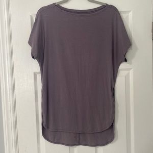 Lululemon T shirt. Size small. Mauve color. Slightly high / low style with slit